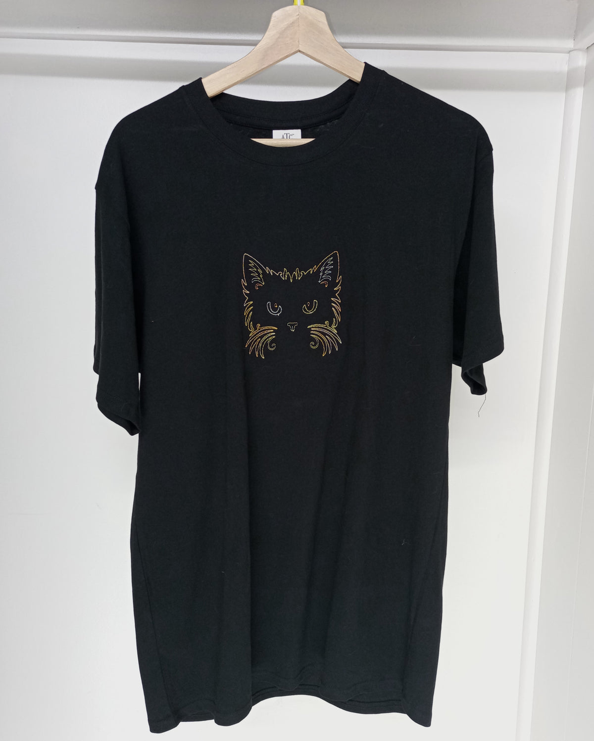 Cat Face - Brown/Orange/Yellow Thread on Black T-Shirt