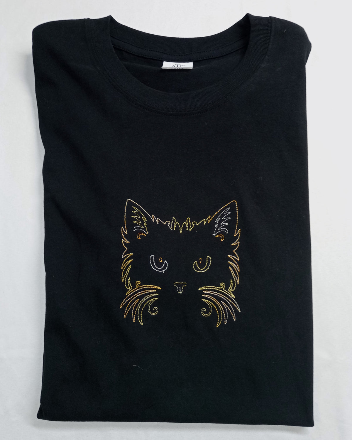 Cat Face - Brown/Orange/Yellow Thread on Black T-Shirt